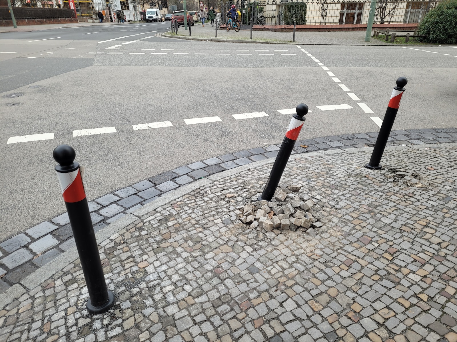 three black and red poles sticking out of the ground